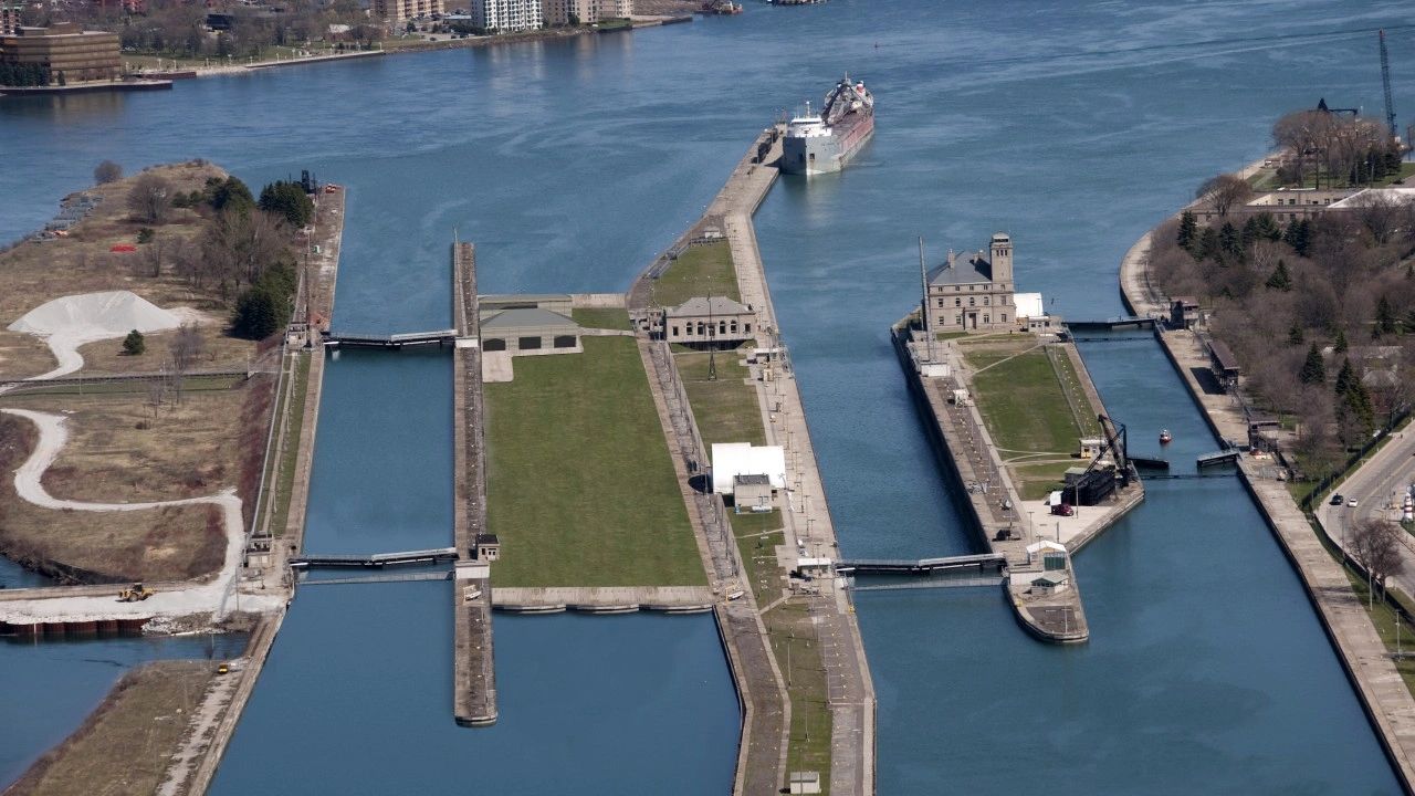Aerial view of waterway locks and cargo ship